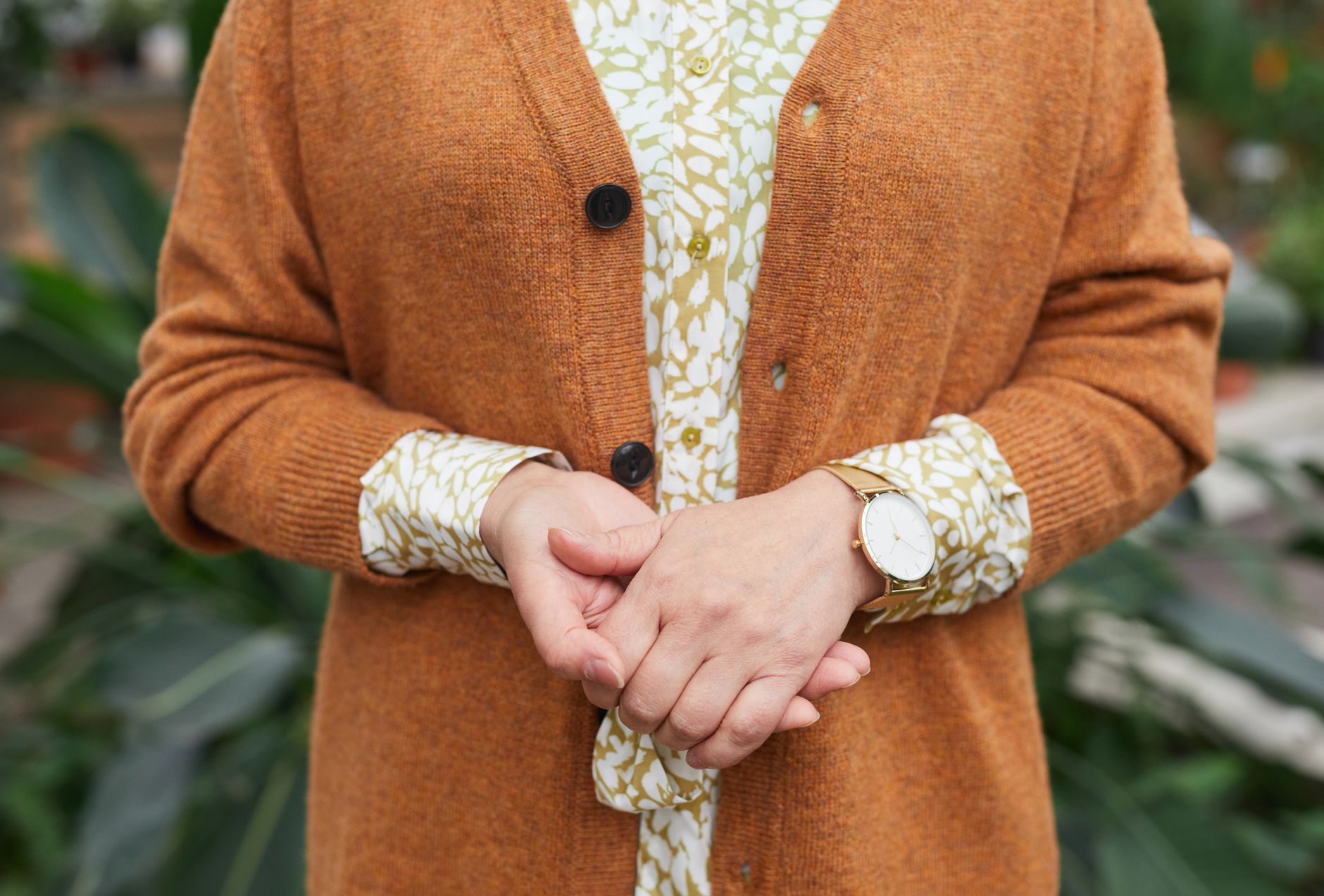 Clean minimalist shirt outfit with subtle metallic accessory detail at the collar