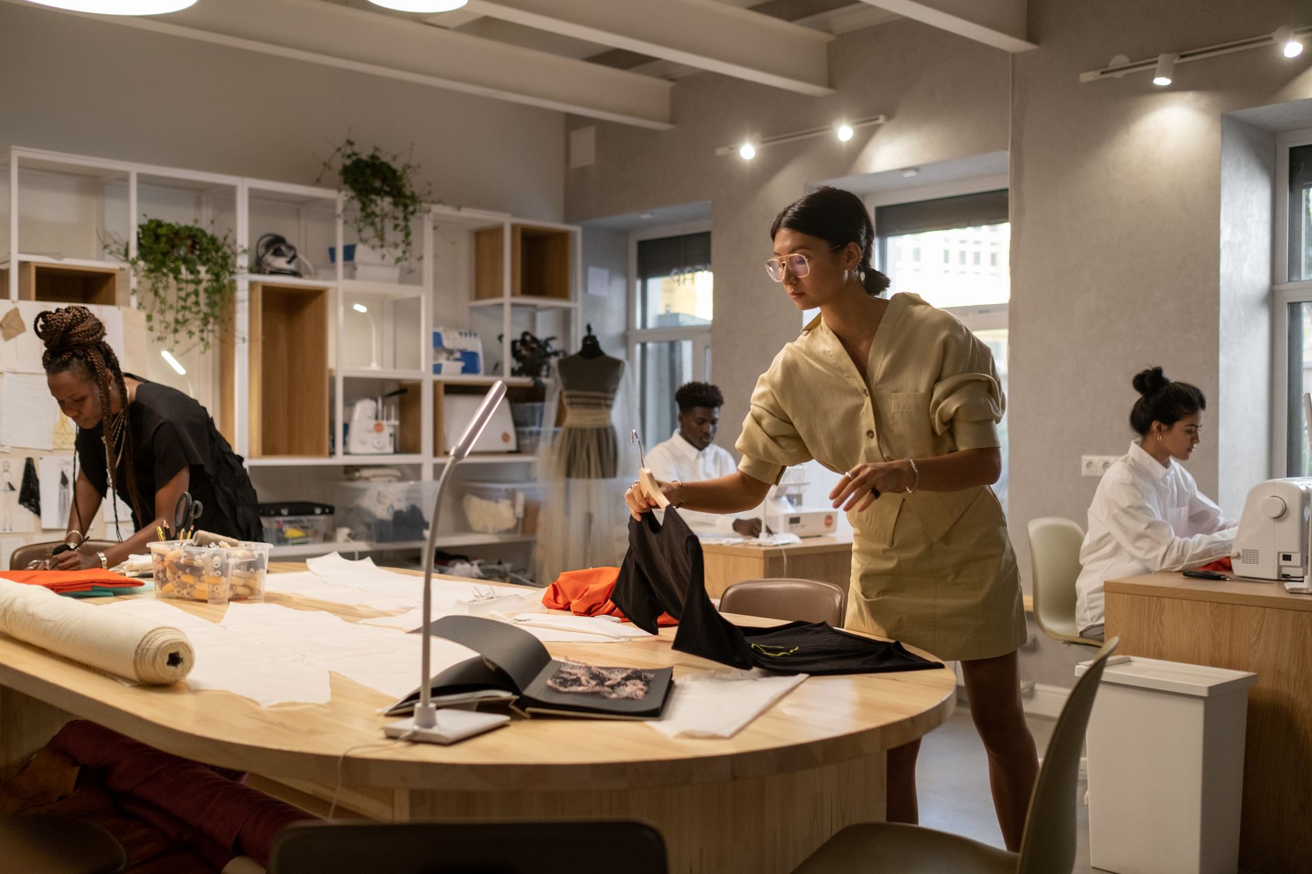 A fashion atelier workroom with garments in construction, showing interior lining and structural elements