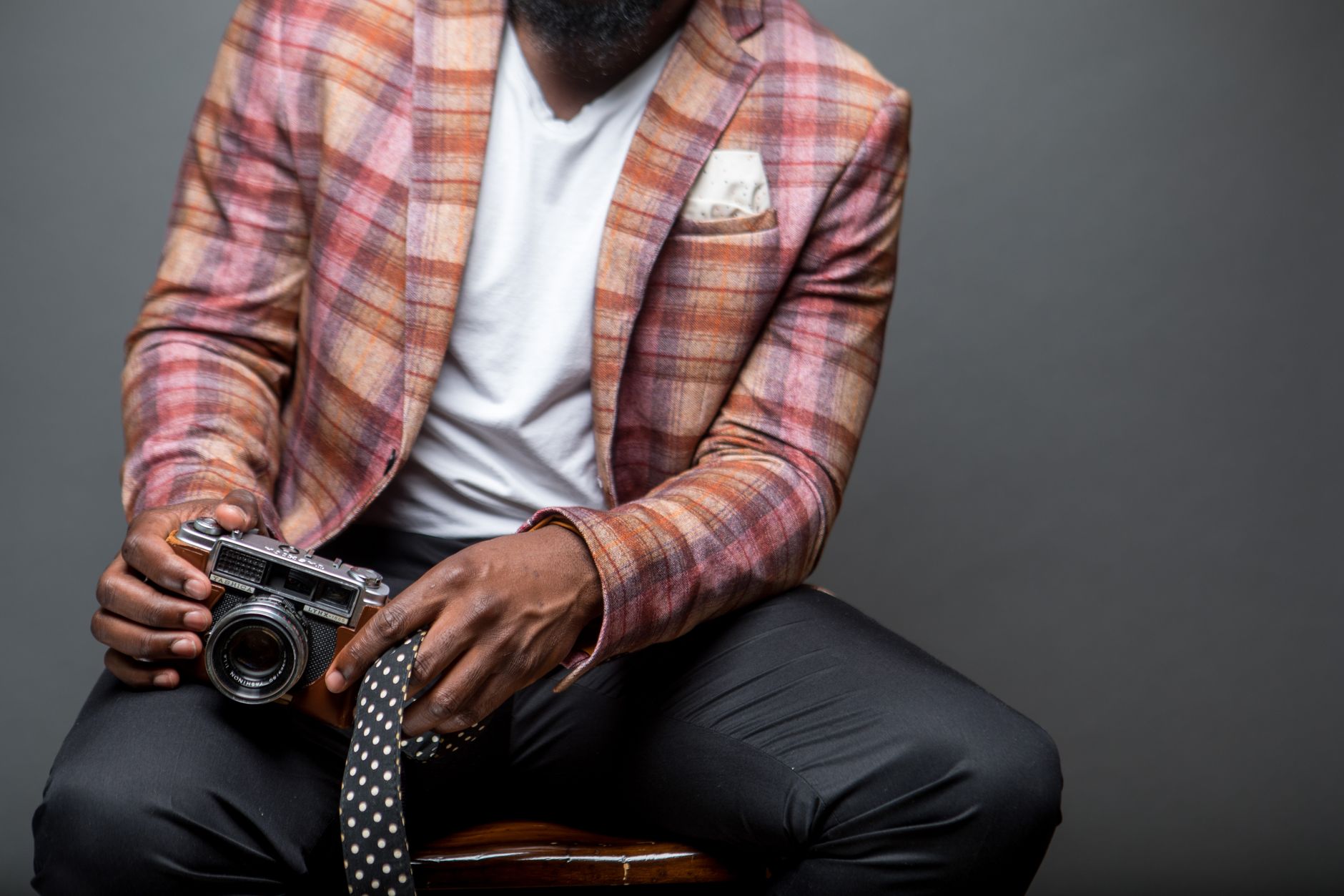 Tailored blazer with sculptural shoulder detail on a clothing rack