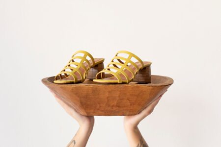 Croquet Hoop Spike Shafts Are Quietly Driving Into Structured Heel Design Close-up of structured high heel shoes with narrow tapered heel columns on a clean surface