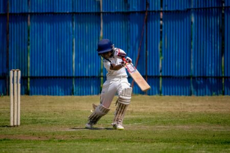 Eton College Cricket Whites Are Quietly Creasing Into Relaxed Suiting Traditional cream cricket whites laid flat showing relaxed trouser cut and flannel fabric texture
