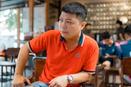 Close-up of a structured polo shirt collar laid flat against the shoulder in a relaxed drape