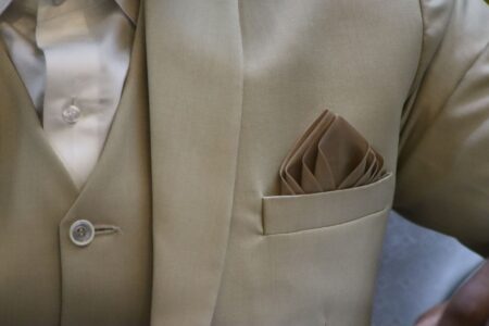 Eton College Tails Coat Silk Facings Are Quietly Lining Structured Lapel Edges Close-up of a structured blazer lapel showing silk edge finishing detail