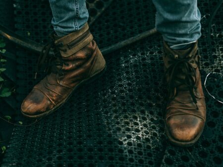 Close-up of leather ankle boots with wrapped strap detailing at the ankle