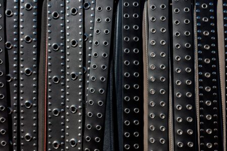 Close-up of a minimalist leather belt tab with a clean slot keeper detail