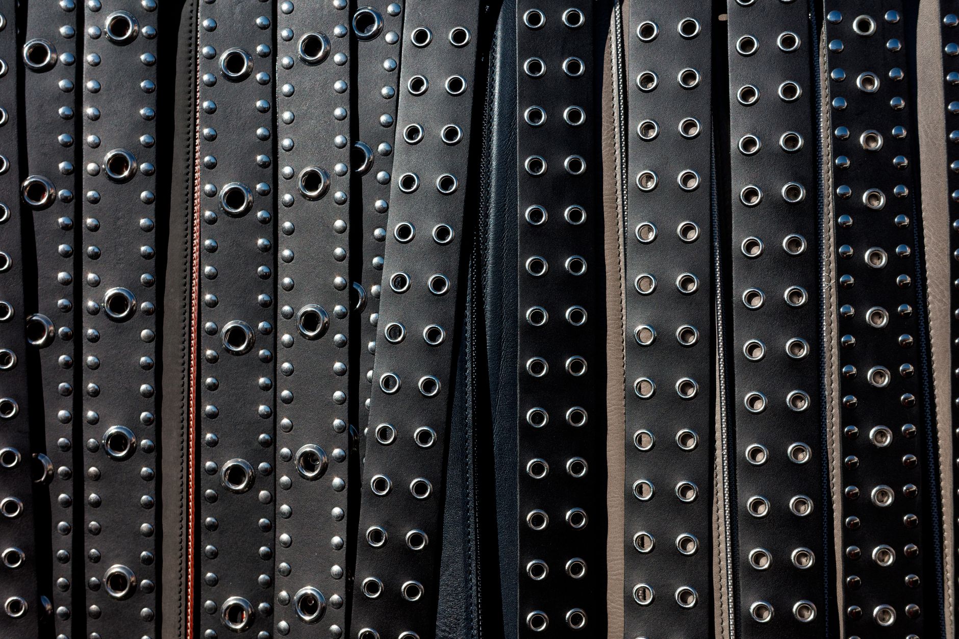 Close-up of a minimalist leather belt tab with a clean slot keeper detail