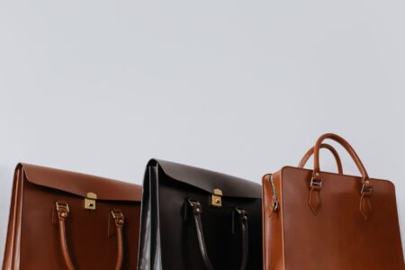 Close-up of structured leather bag with metal handle loop hardware detail