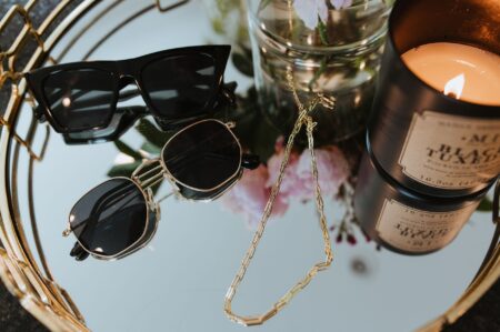 Close-up of layered gold chain necklaces with interlocking hardware links on a neutral background