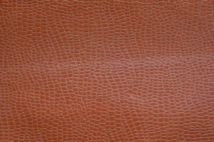 Close-up of pebbled saddle seat leather surface showing natural grain and matte finish