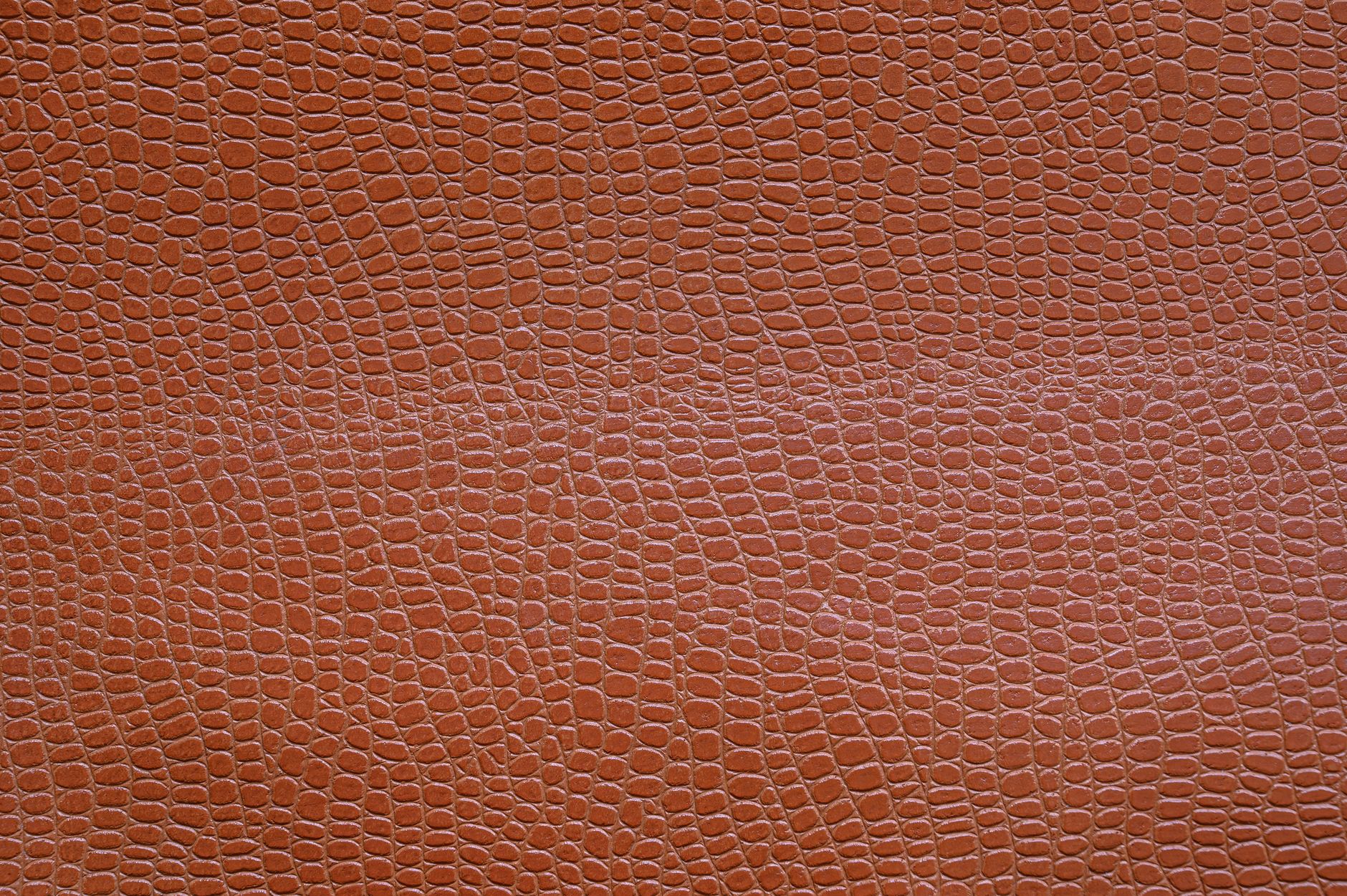 Close-up of pebbled saddle seat leather surface showing natural grain and matte finish
