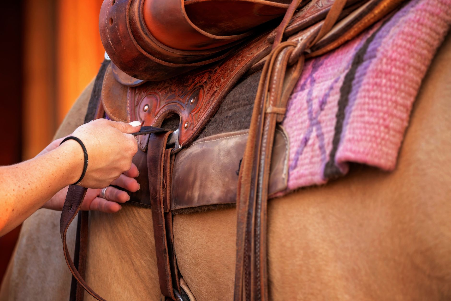 Detailed view of leather saddle cantle binding with tight saddle stitching along the edge