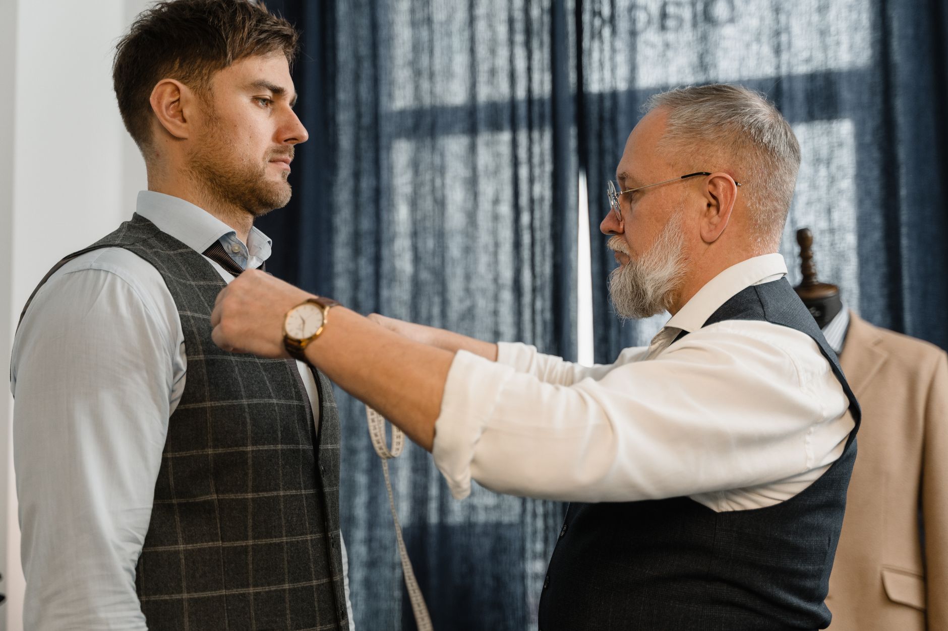 Tailor working on hand-finishing details of a structured coat front placket