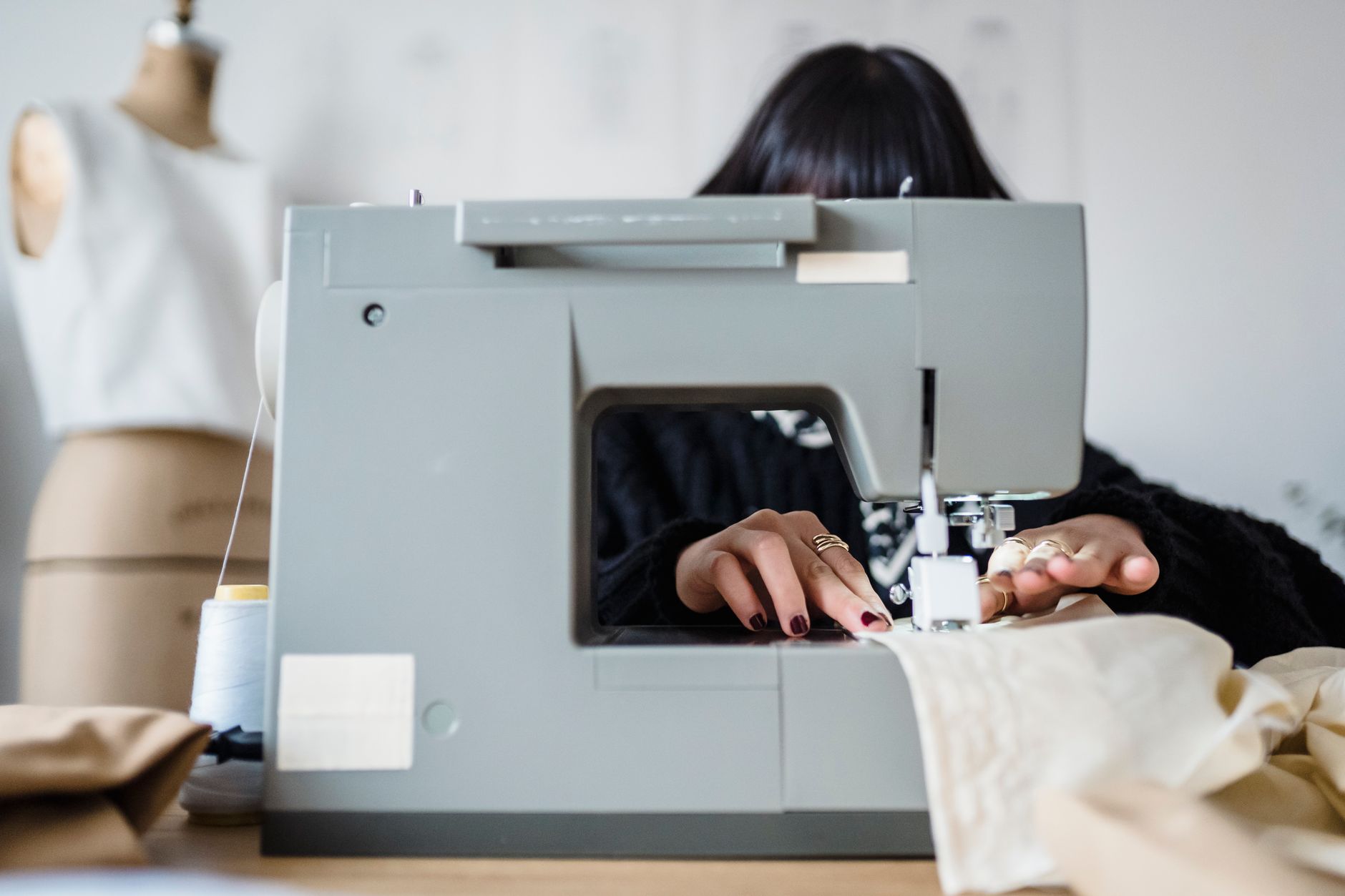 Tailor working on structured garment seams in a professional atelier setting